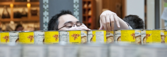 Russ Wong stacks cans for Canstruction.