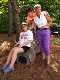 Wendy Vollans and her two children stand by the memorial rock.