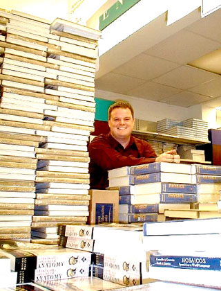 [MacIntyre with tower of books]